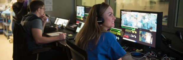 Surgical Education Fellow Dr. Brittany Hasty monitors an interprofessional simulation from the control room.